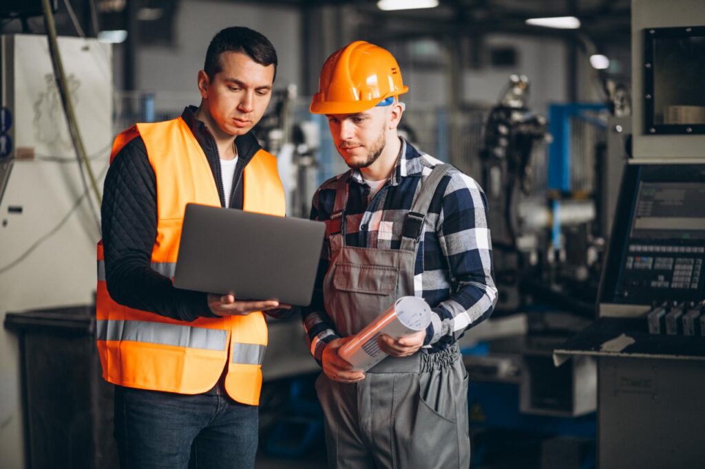 A maintenance manager and maintenance worker discuss a job