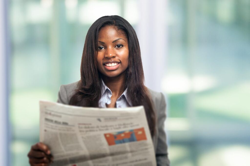 A female recruiter checks her latest job advert in a paper